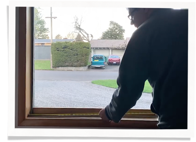 man measuring a window